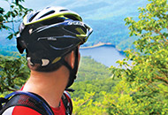 Man in bike helmet overlooking valley