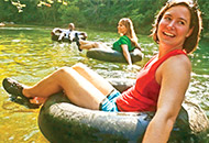 woman in tiretube on river